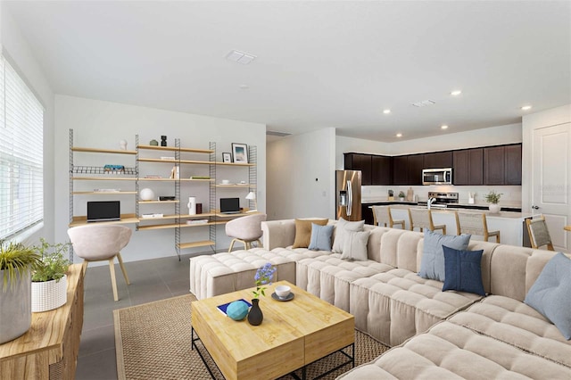 living room featuring built in desk and light tile patterned floors