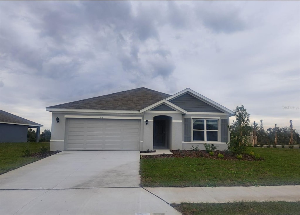 view of front of property with a front lawn and a garage