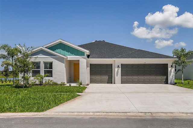 view of front of house featuring driveway, roof with shingles, an attached garage, board and batten siding, and stucco siding