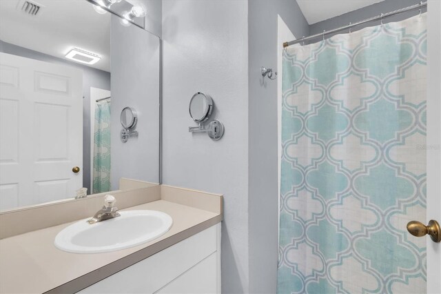 bathroom featuring vanity and a shower with shower curtain