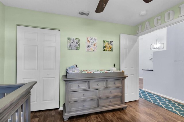 bedroom featuring ceiling fan, dark wood-type flooring, and a closet