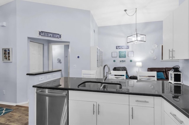 kitchen featuring dishwasher, sink, white cabinetry, hanging light fixtures, and hardwood / wood-style floors