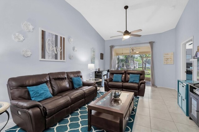 tiled living room with ceiling fan and high vaulted ceiling