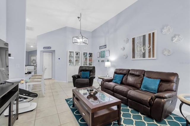 tiled living room featuring an inviting chandelier and high vaulted ceiling