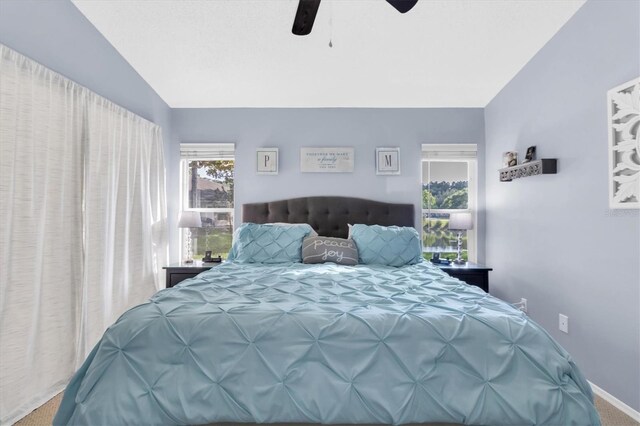 carpeted bedroom with vaulted ceiling and ceiling fan