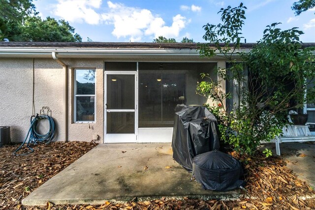 entrance to property with a patio area