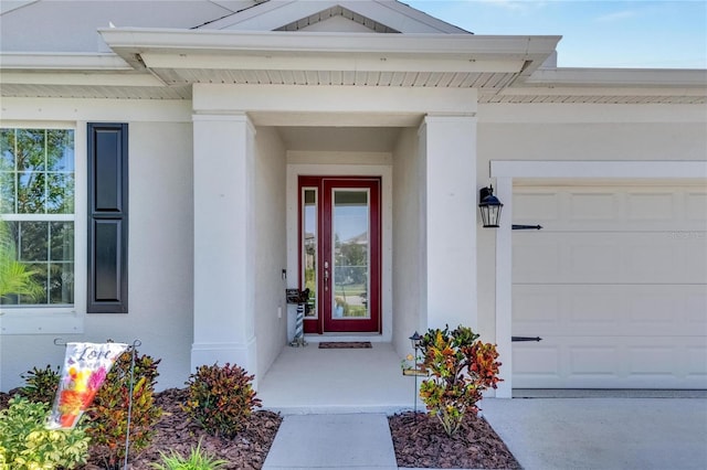 doorway to property with a garage