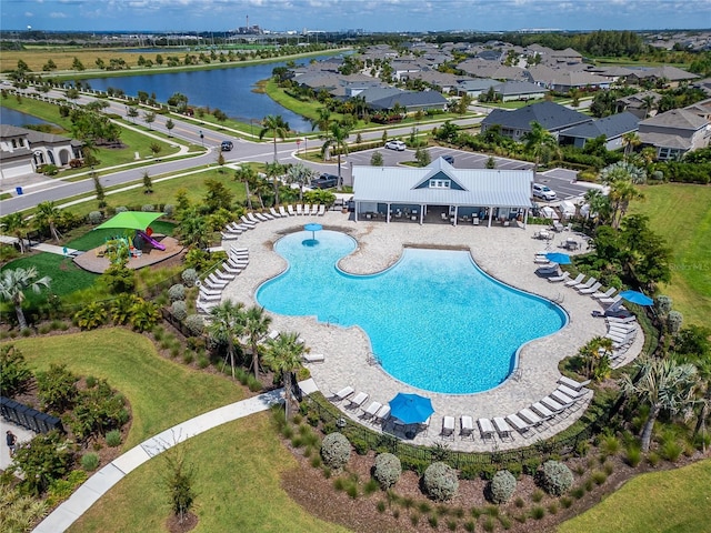 view of swimming pool featuring a patio area and a water view