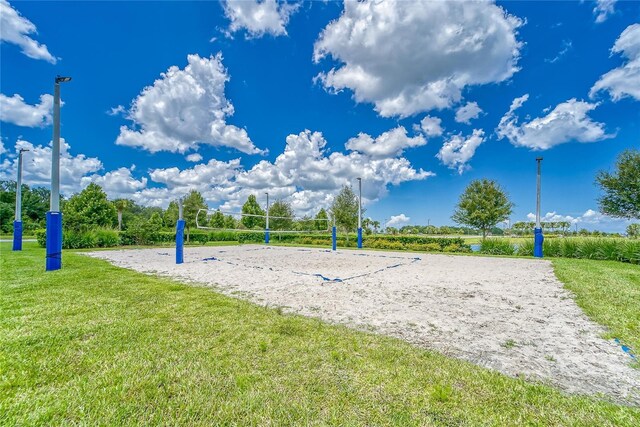 view of community featuring a lawn and volleyball court