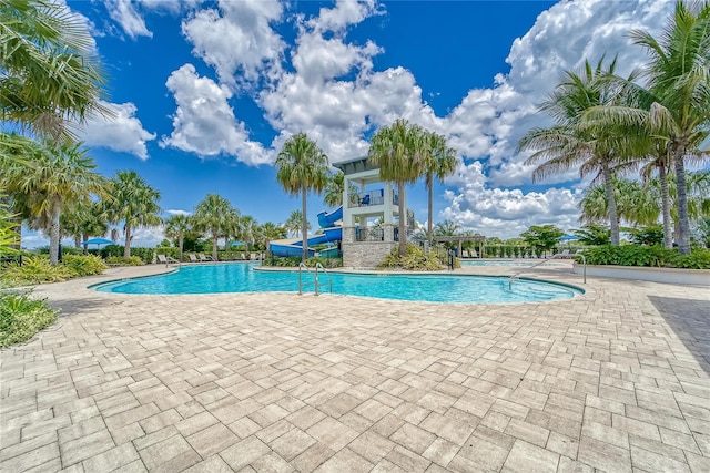 view of swimming pool featuring a patio and a water slide