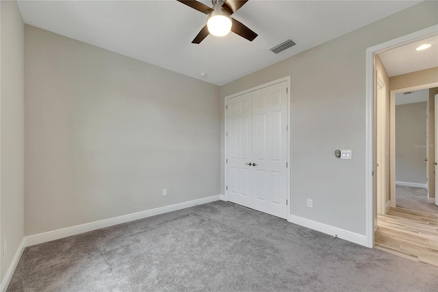 unfurnished bedroom featuring carpet floors, a closet, and ceiling fan