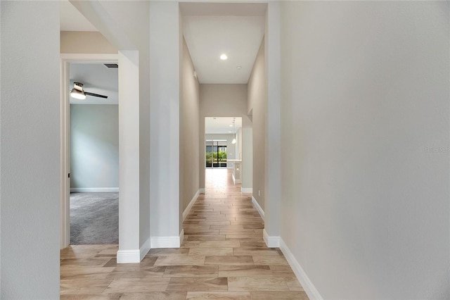 corridor with light hardwood / wood-style flooring