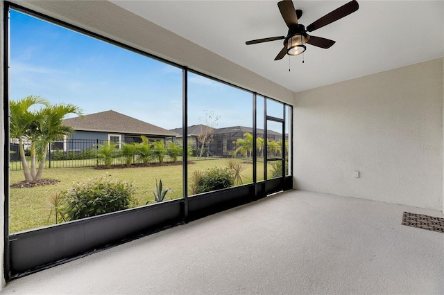 unfurnished sunroom featuring plenty of natural light and ceiling fan