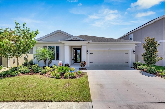 view of front of house featuring a garage and a front yard