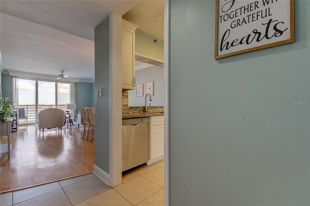 hallway with light hardwood / wood-style flooring and sink