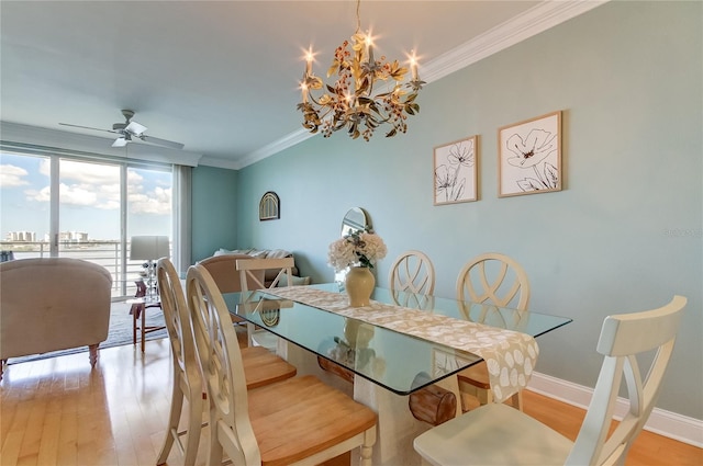 dining room with ceiling fan with notable chandelier, ornamental molding, and light hardwood / wood-style flooring