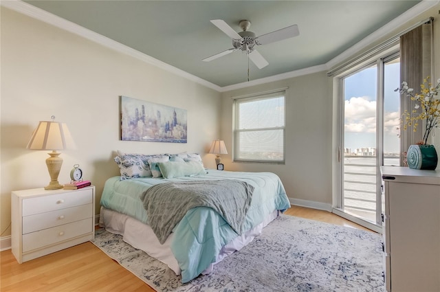 bedroom featuring ceiling fan, access to outside, light hardwood / wood-style floors, and multiple windows