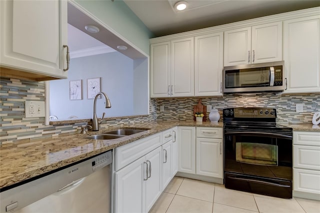 kitchen featuring stainless steel appliances, white cabinetry, tasteful backsplash, and sink