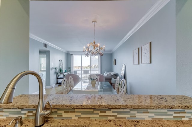 unfurnished dining area featuring crown molding and a notable chandelier