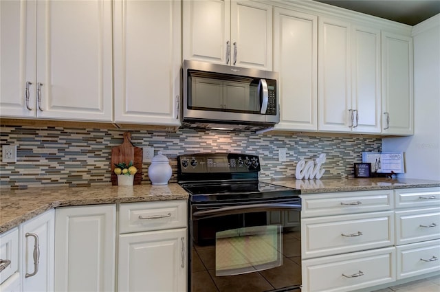 kitchen featuring light stone countertops, white cabinetry, black range with electric cooktop, and tasteful backsplash