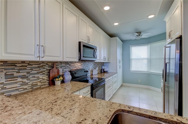 kitchen featuring ceiling fan, white cabinets, backsplash, stainless steel appliances, and light stone countertops