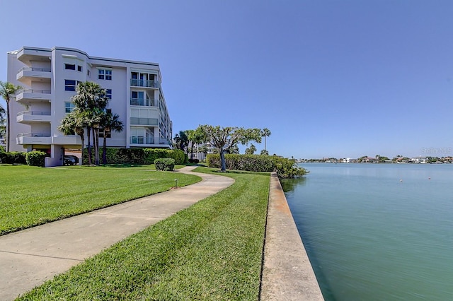 exterior space featuring a lawn and a water view