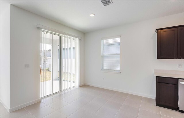 unfurnished dining area with light tile patterned floors