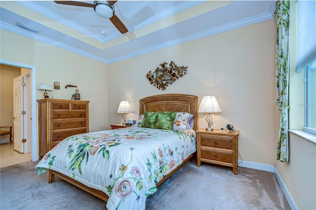 bedroom featuring crown molding, a raised ceiling, ceiling fan, and carpet flooring