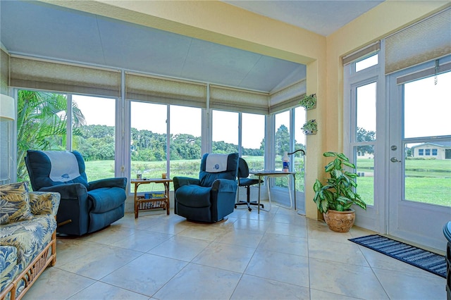 sunroom / solarium featuring plenty of natural light and vaulted ceiling