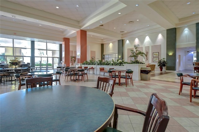 dining area with a high ceiling and light tile patterned floors