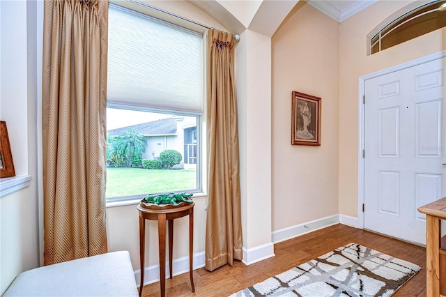 entrance foyer featuring hardwood / wood-style flooring and crown molding