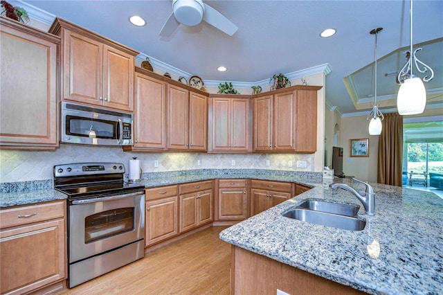 kitchen featuring sink, hanging light fixtures, ornamental molding, stainless steel appliances, and light stone countertops