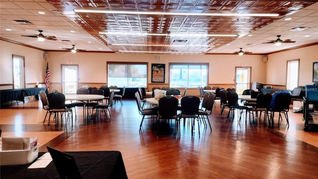 dining area featuring hardwood / wood-style flooring and ornamental molding