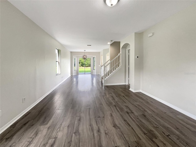 unfurnished living room featuring dark wood-type flooring