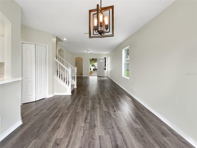 interior space with an inviting chandelier and dark hardwood / wood-style flooring