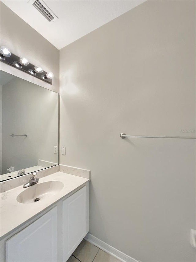 bathroom featuring tile patterned flooring and vanity