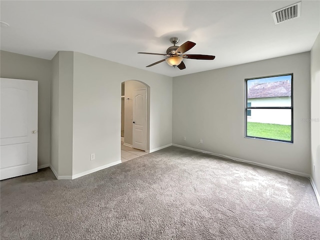 spare room featuring light carpet and ceiling fan