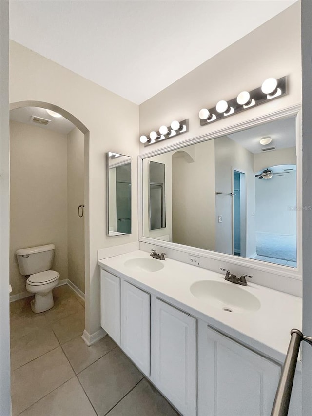 bathroom with ceiling fan, vanity, tile patterned flooring, and toilet