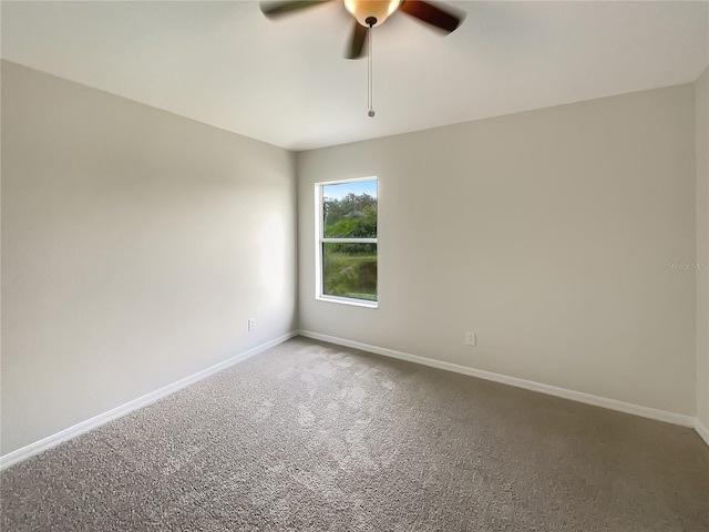 carpeted spare room featuring ceiling fan