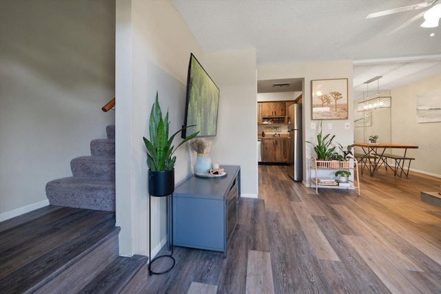 interior space featuring a textured ceiling and dark hardwood / wood-style floors