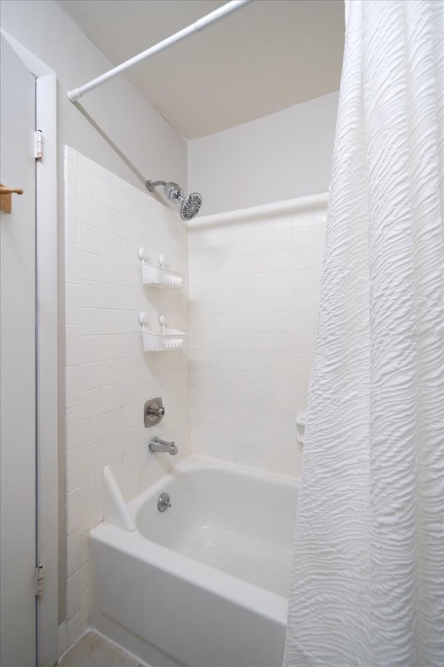 bathroom with shower / bath combination with curtain