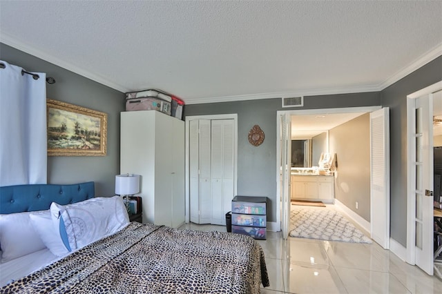 bedroom with visible vents, ornamental molding, connected bathroom, a closet, and a textured ceiling
