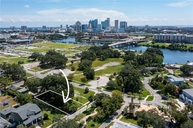 drone / aerial view featuring a city view and a water view