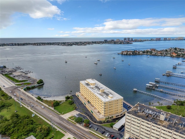 drone / aerial view featuring a city view and a water view