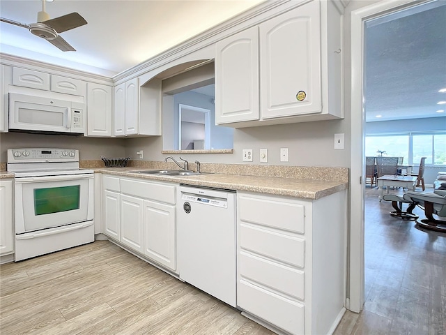 kitchen with ceiling fan, sink, white appliances, and white cabinetry