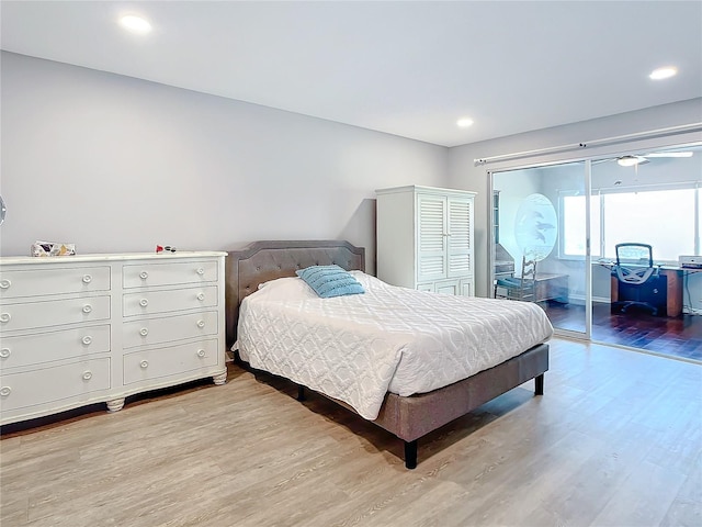 bedroom with light wood-type flooring and access to exterior