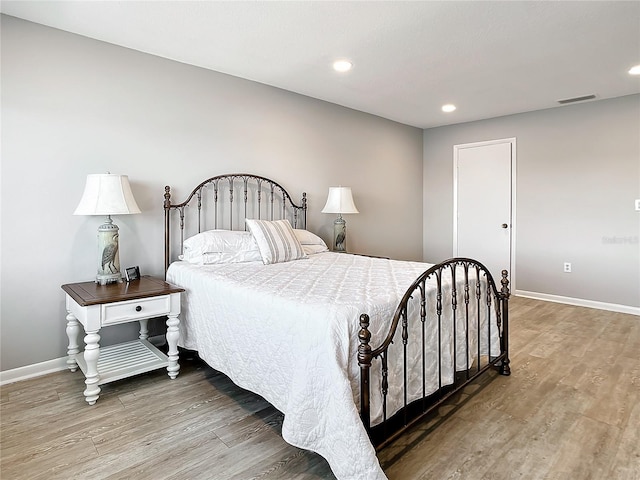 bedroom with hardwood / wood-style floors