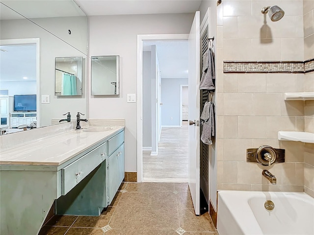 bathroom featuring wood-type flooring, shower / tub combination, and vanity