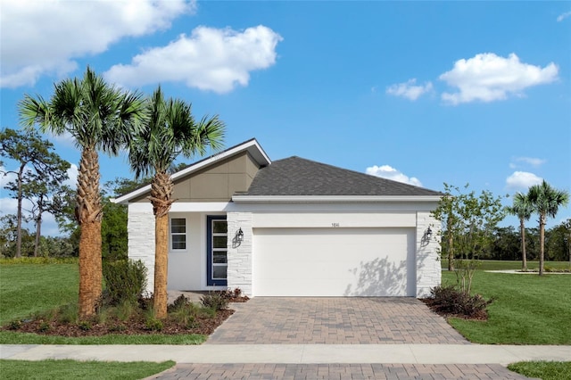 view of front of house featuring a front yard and a garage