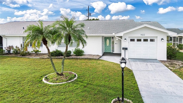 single story home featuring a garage and a front lawn